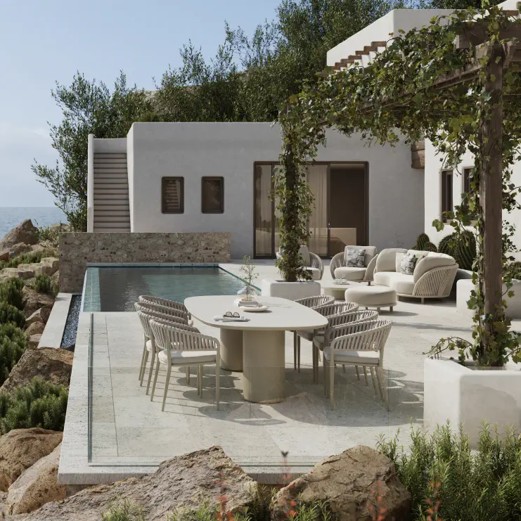 Stijlvol terras met tuintafel en stoelen van Amico, met op de achtegrond een zwembad en zonnige villa